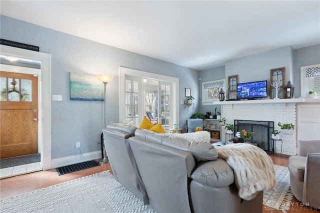 living room with a fireplace and light hardwood / wood-style floors