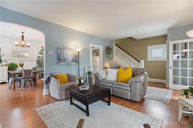 living room featuring hardwood / wood-style flooring and a chandelier