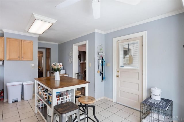 kitchen featuring crown molding, light brown cabinetry, and light tile patterned floors