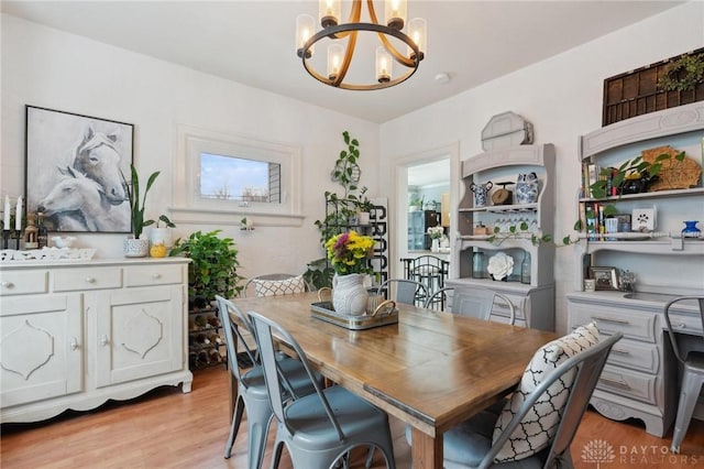 dining room with a notable chandelier and light hardwood / wood-style flooring