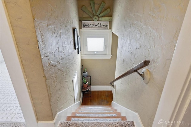 stairs featuring hardwood / wood-style flooring