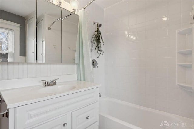 bathroom featuring shower / bath combination with curtain, vanity, and decorative backsplash