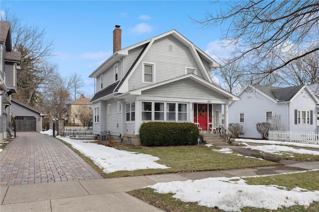 view of front of home with an outbuilding, a garage, and a front lawn