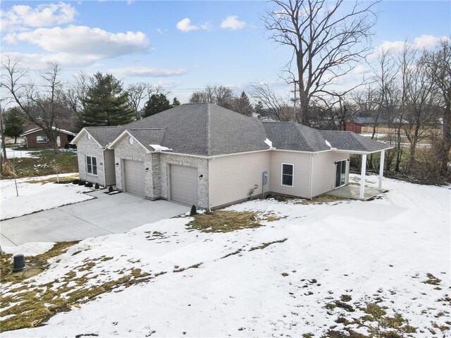 view of snow covered exterior with a garage