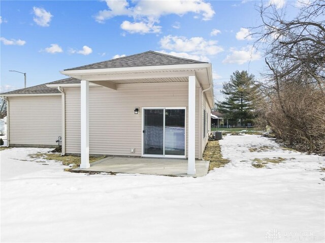 snow covered property featuring central air condition unit