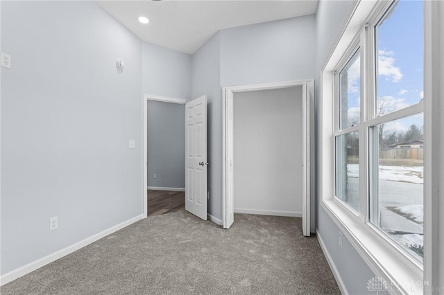 unfurnished bedroom featuring light carpet