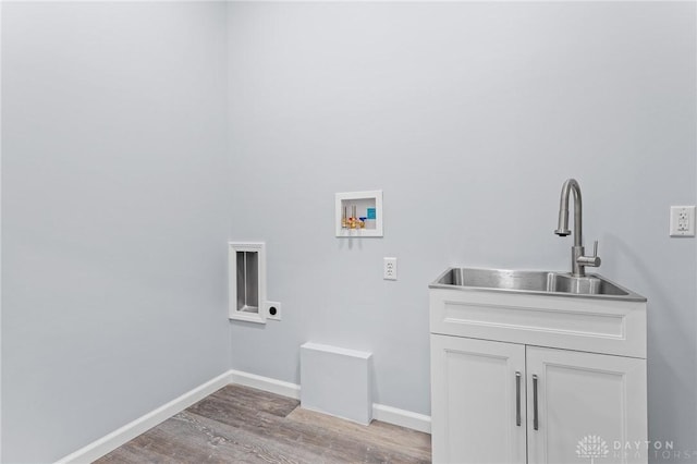 washroom with sink, hookup for an electric dryer, hookup for a washing machine, and light wood-type flooring