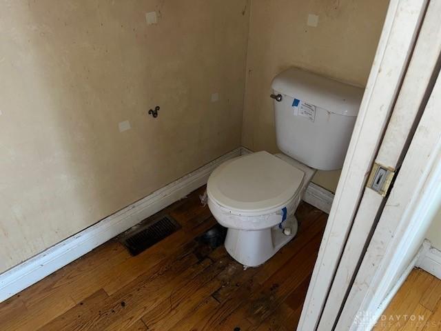 bathroom featuring hardwood / wood-style floors and toilet