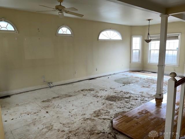 spare room with ornate columns and ceiling fan