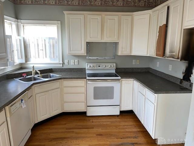 kitchen with white cabinetry, sink, white appliances, and dark hardwood / wood-style floors