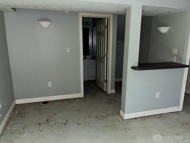 unfurnished room featuring a textured ceiling