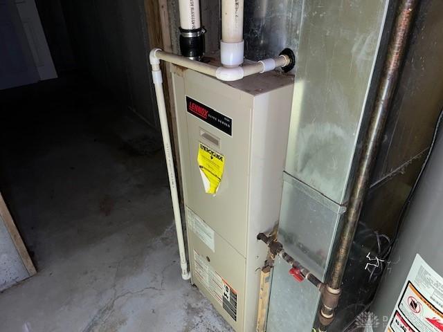 utility room featuring heating unit