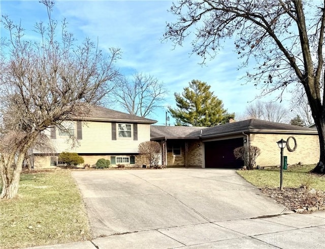 view of front of property with a garage and a front lawn