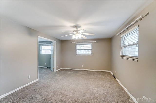 carpeted empty room featuring ceiling fan