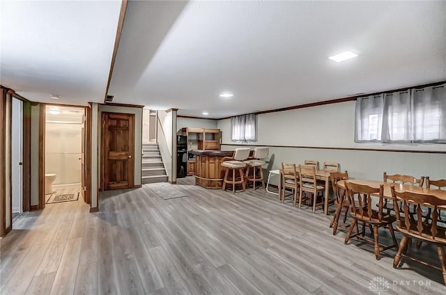 interior space with ornamental molding, light hardwood / wood-style floors, and plenty of natural light