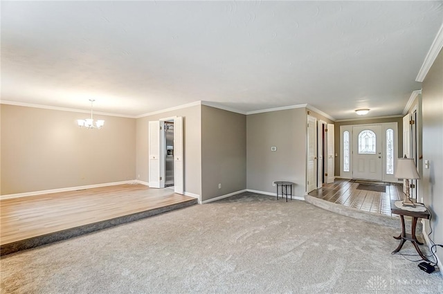 entryway featuring a notable chandelier, carpet floors, and ornamental molding