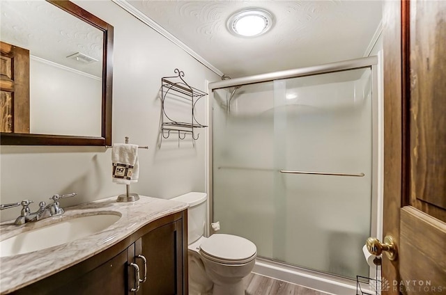 bathroom with hardwood / wood-style flooring, vanity, walk in shower, toilet, and a textured ceiling