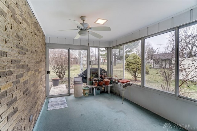 unfurnished sunroom featuring ceiling fan