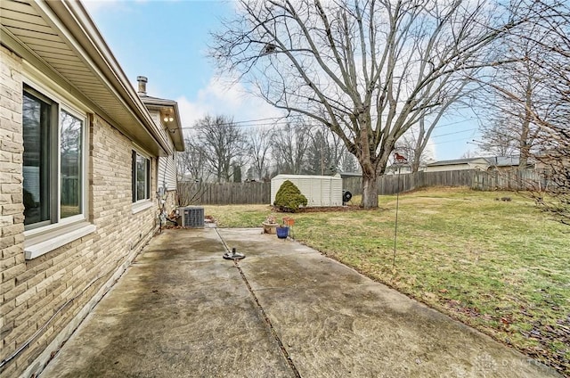 view of yard featuring a storage shed, a patio area, and central air condition unit