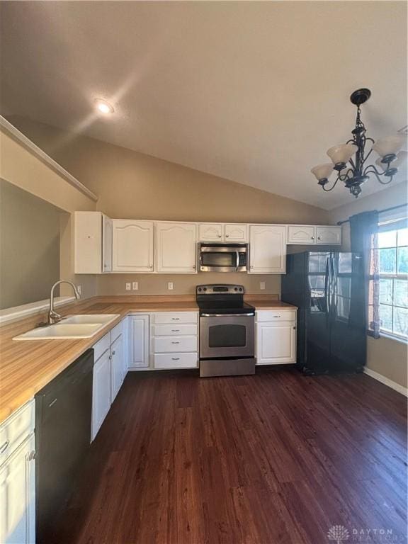 kitchen featuring sink, decorative light fixtures, black appliances, and white cabinets