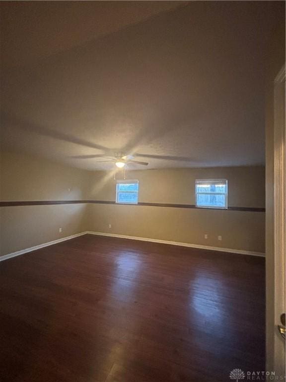 empty room featuring dark hardwood / wood-style floors and ceiling fan