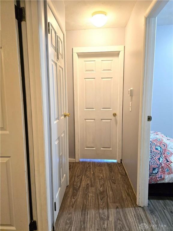 hallway with dark wood-type flooring