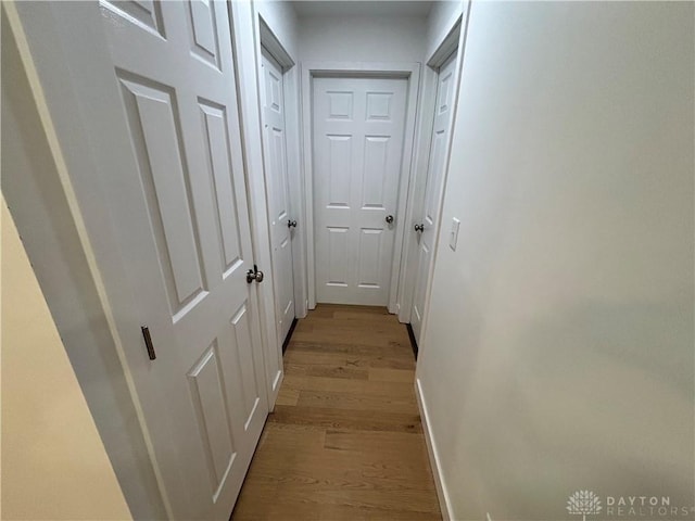 hallway with light hardwood / wood-style flooring