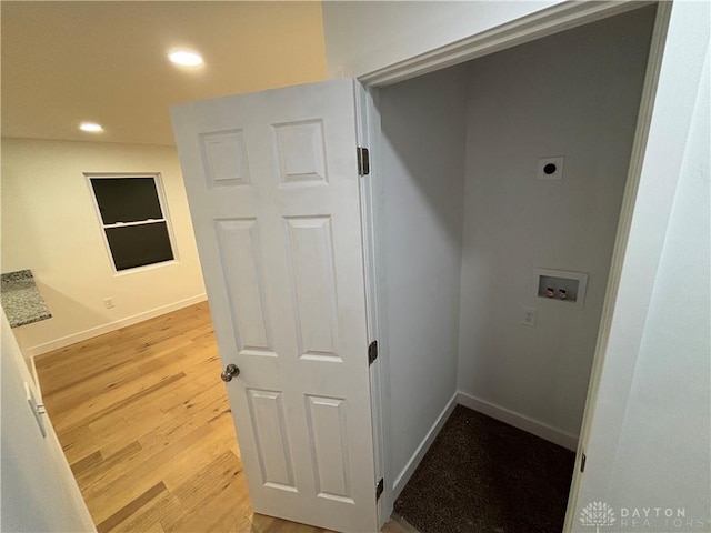 washroom featuring hookup for an electric dryer, washer hookup, and light wood-type flooring