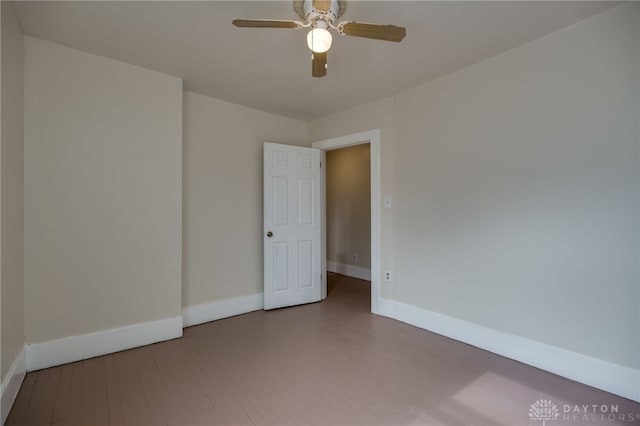 spare room featuring hardwood / wood-style flooring and ceiling fan