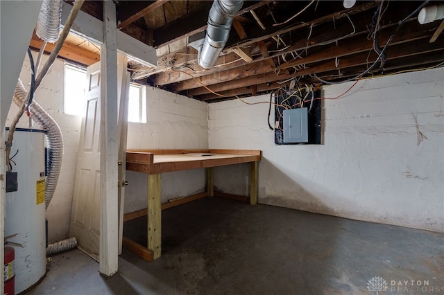 basement featuring electric panel and water heater