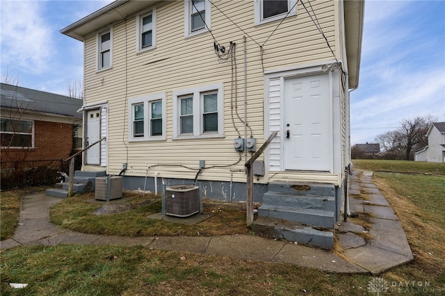 rear view of house featuring central AC unit