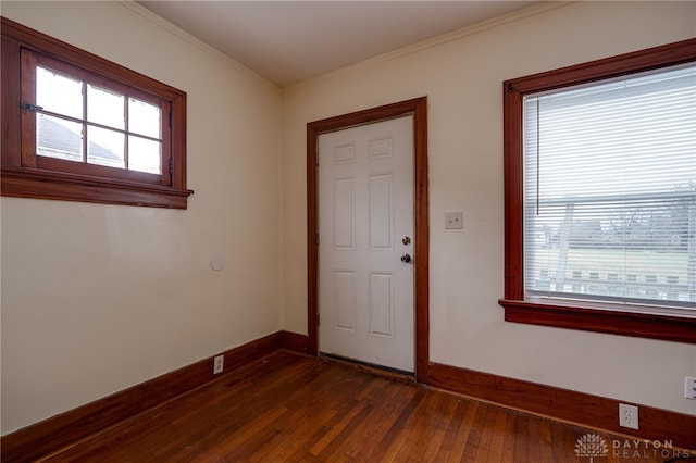 entrance foyer with dark wood-type flooring and ornamental molding