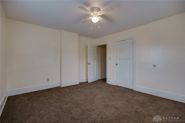 carpeted spare room featuring ceiling fan