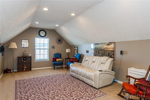 living room featuring lofted ceiling, radiator heating unit, light carpet, and a textured ceiling