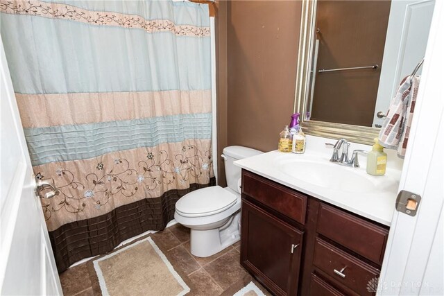 bathroom featuring vanity, toilet, and a shower with shower curtain