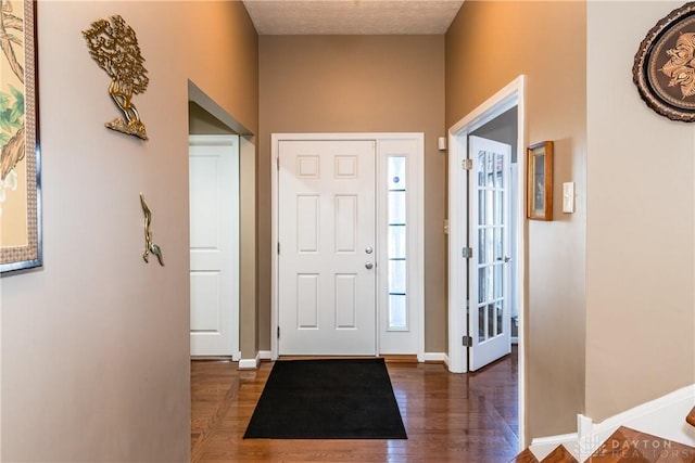 foyer entrance with dark wood-type flooring