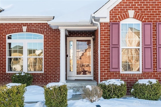 view of snow covered property entrance