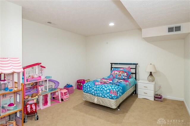 bedroom featuring carpet and a textured ceiling