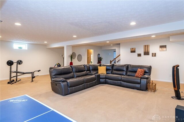 carpeted living room featuring a textured ceiling