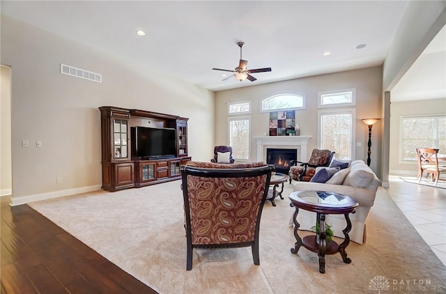 living room featuring light hardwood / wood-style floors and ceiling fan