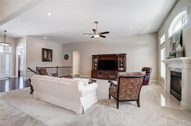 living room featuring ceiling fan and plenty of natural light