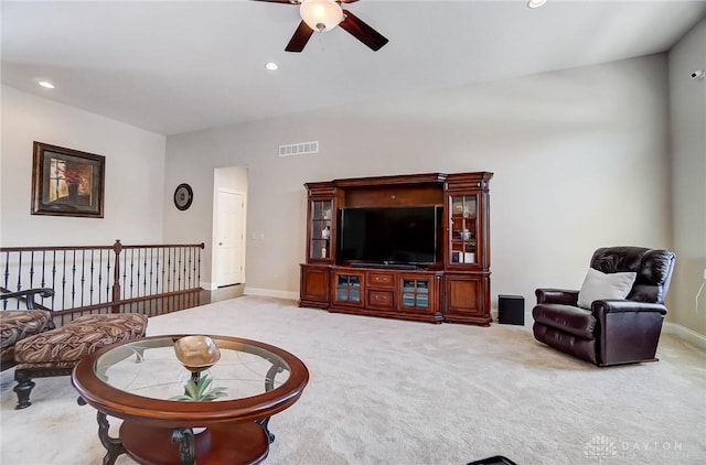 living room with ceiling fan and carpet