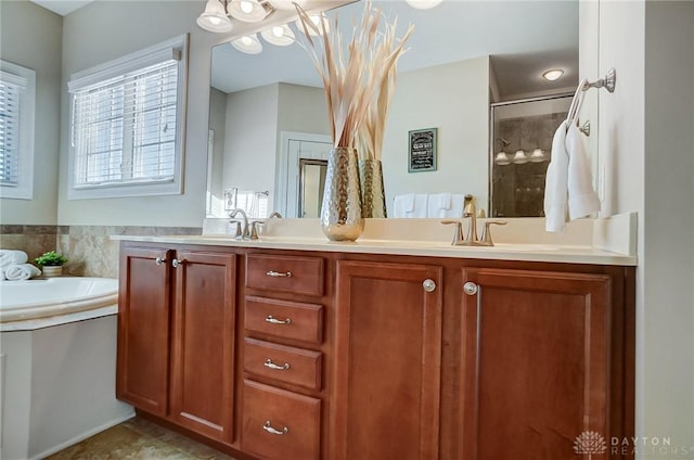 bathroom featuring vanity and independent shower and bath