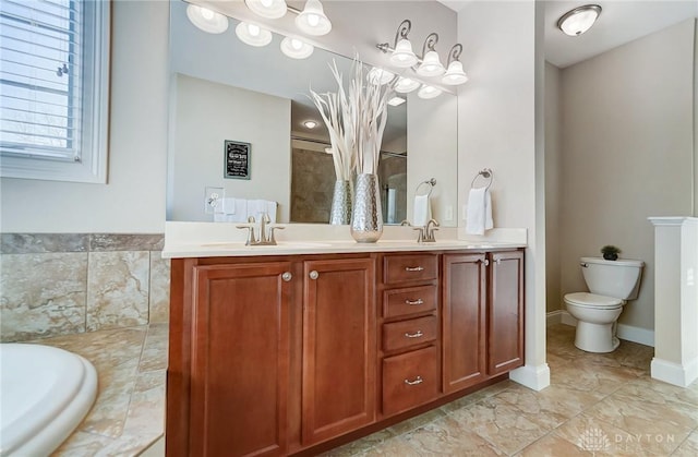 bathroom with a relaxing tiled tub, vanity, and toilet