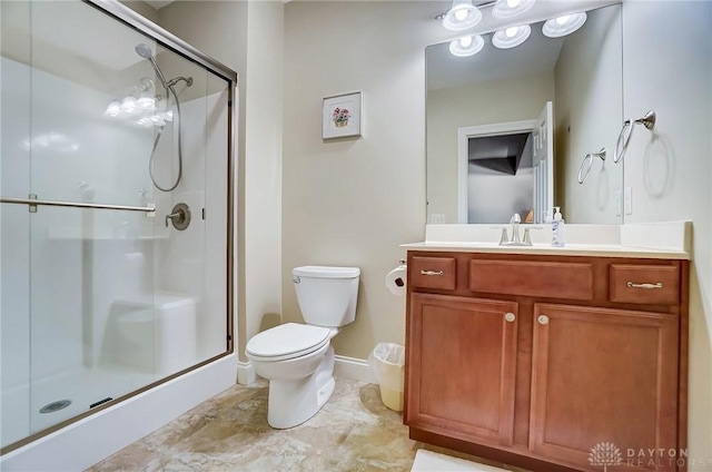 bathroom featuring an enclosed shower, vanity, and toilet