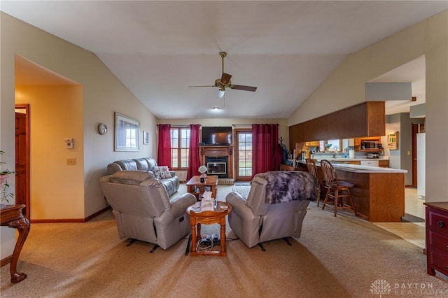 carpeted living room with lofted ceiling and ceiling fan