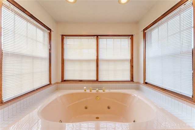 bathroom with a relaxing tiled tub