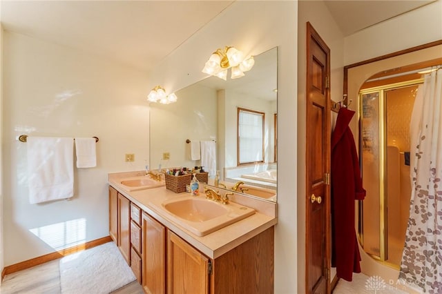 bathroom with vanity and a shower with door