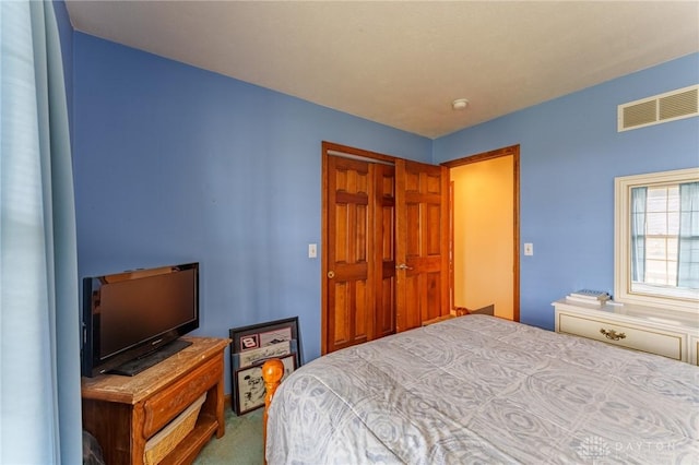 carpeted bedroom with a closet