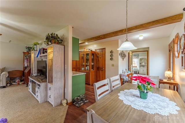 dining area with beamed ceiling